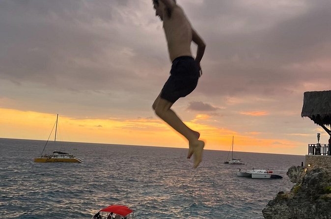 ATV Ride, Negril 7 mile Beach Catamaran Cruise & Ricks cafe Combo - Rick’s Cafe sunset finale: food, music or DJ, and cliff-jump style fun