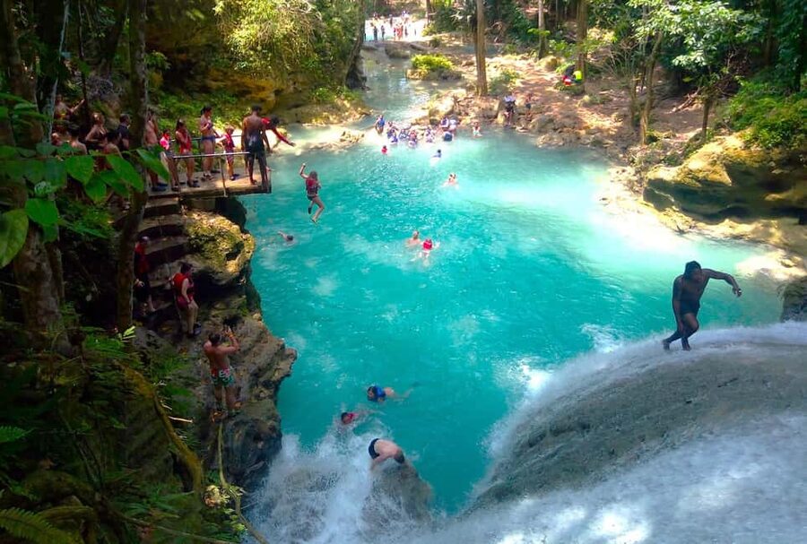 From Runaway Bay: Island Gully Falls and Blue Hole Tour - Your 1-hour guided water adventure: ropes, swimming under the falls, and caves