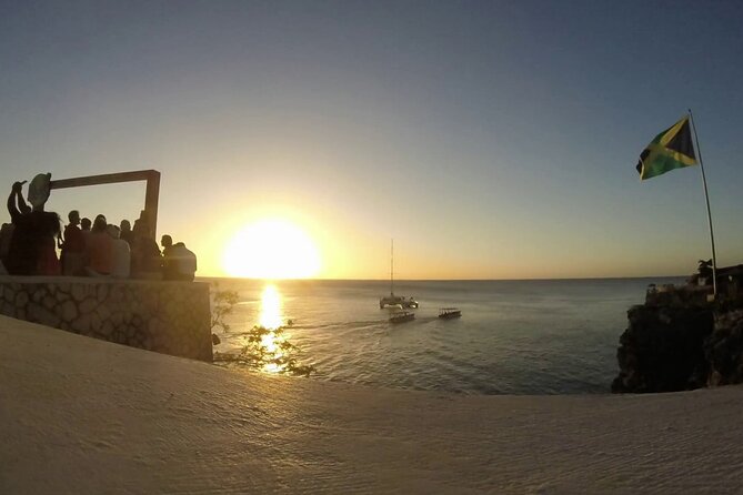 Private Trip to Blue Hole Mineral Springs, Negril & Ricks Café - Rick’s Cafe sunset: cliffside action, reggae vibes, and that big view